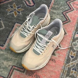 On Running Cream and Gray Sneakers